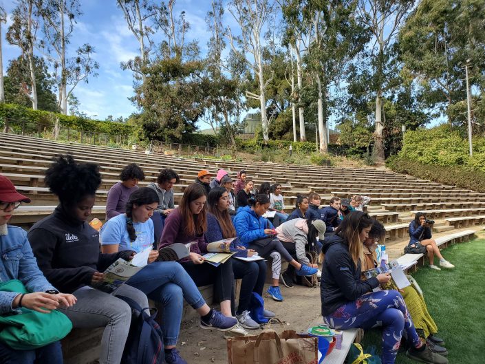 UCLA community students sit and listen in Sunset Recreation.