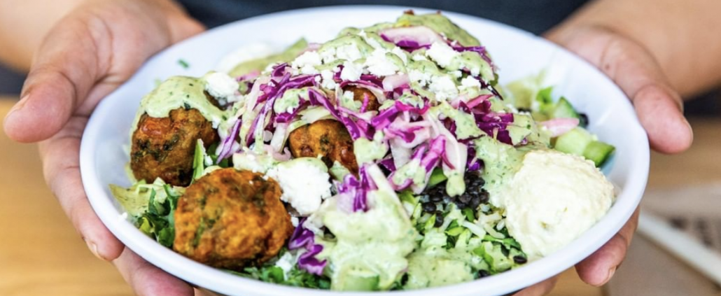 person holding a falafel salad