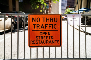 No thru traffic orange sign