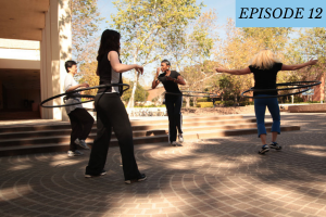 Episode 12 featured image: A group of people hula hoop with one another