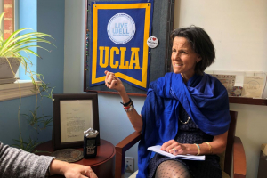 Dr. Slusser engages in conversation with another individual in the UCLA LiveWell office.