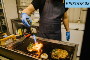 Episode 28 featured image: a chef torches a dish on the grill