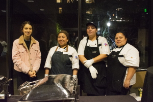 A UCLA staff smiling next to a tray.
