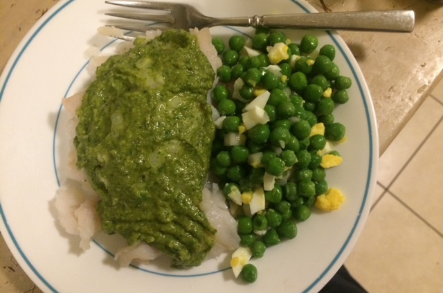 A fish dish with assorted veggies on the side.