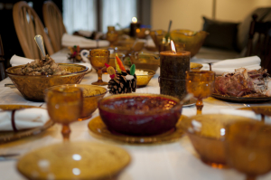 A closeup of a Thanksgiving dinner table with a variety of dishes.