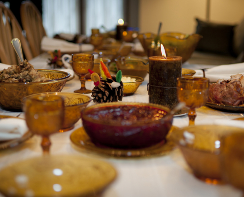 A closeup of a Thanksgiving dinner table with a variety of dishes.
