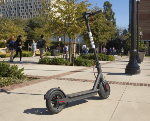 Bird scooter is placed in the middle of the walkway.