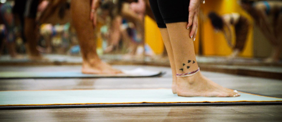 Students practice yoga with one another in a UCLA fitness class.