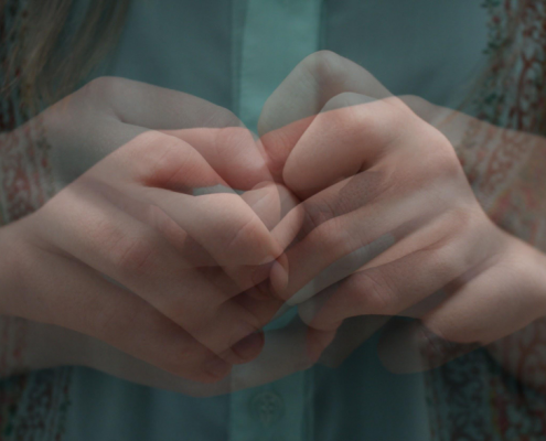 An overlayed picture of a person holding their hands together anxiously.