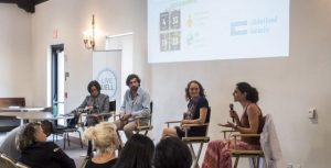 A group of panelists speak to an audience.