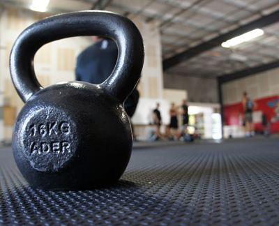A dumbbell sits in the middle of the gym.