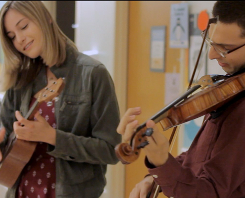 2 students play instruments in the UCLA children's hospital.