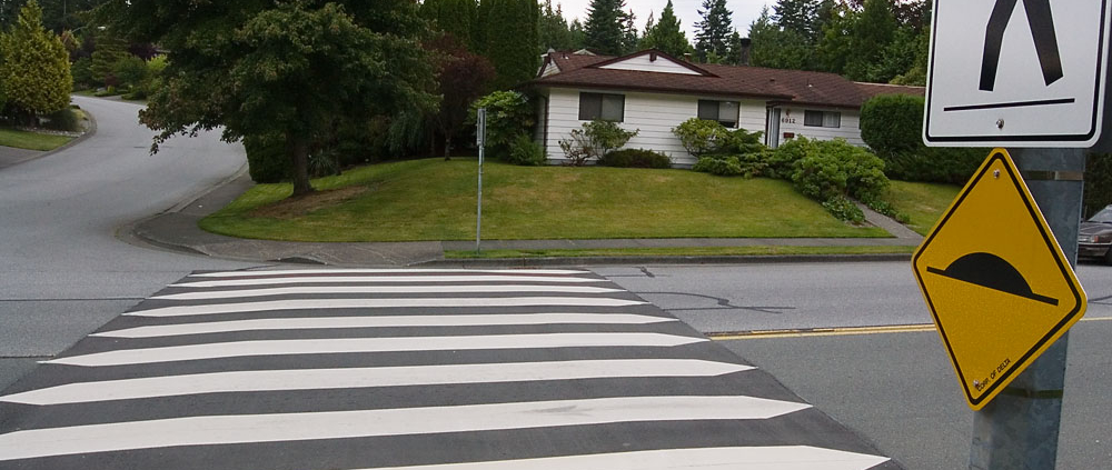 A crosswalk with a sign next to it.