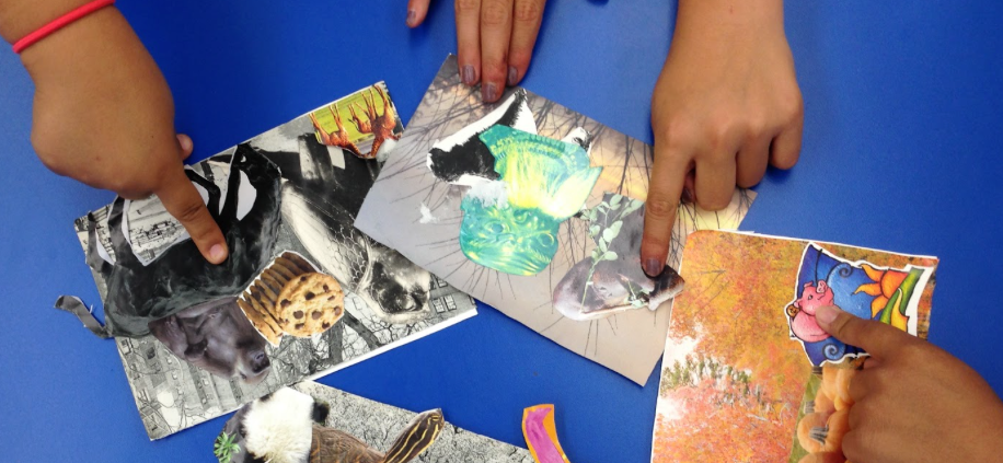 Small hands point to an arts and crafts collage project.