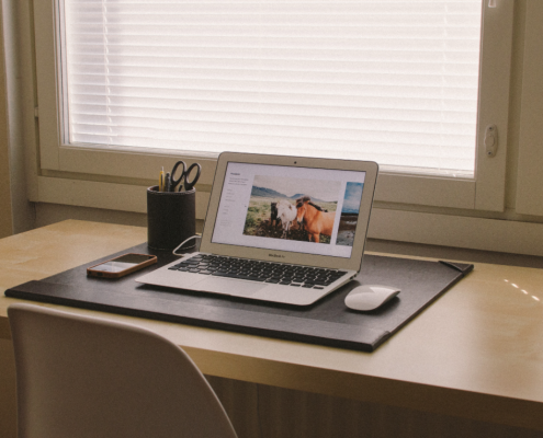 open laptop sitting on top of a table