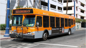 An orange bus is parked on the side of a road.