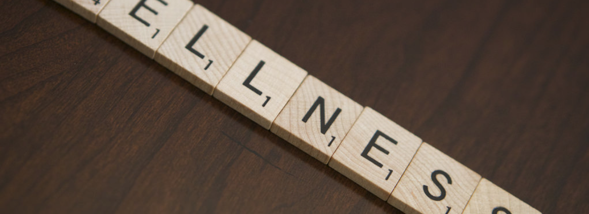 Wooden blocks spell out Wellness.