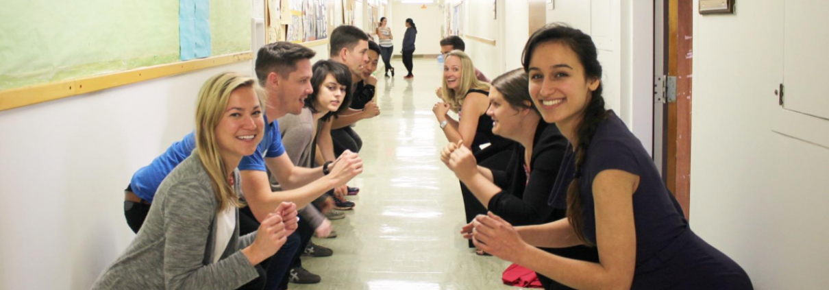 2 lines of people squat in the hallway.