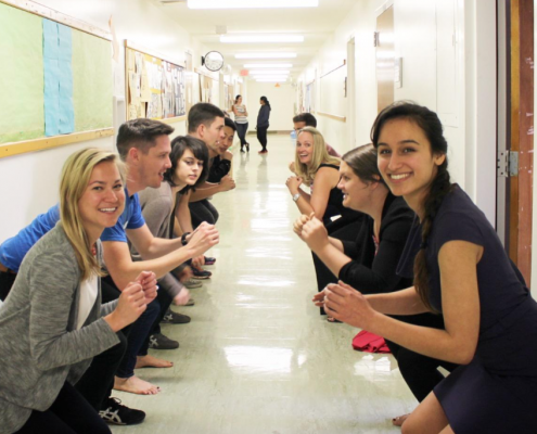 2 lines of people squat in the hallway.