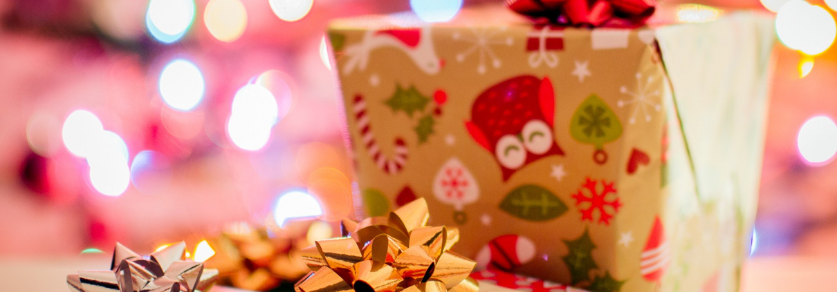 Multiple presents are wrapped in gift wrap with a bow on top.