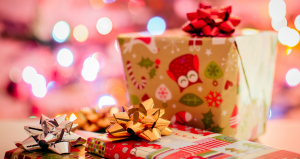 Multiple presents are wrapped in gift wrap with a bow on top.