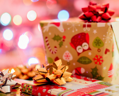 Multiple presents are wrapped in gift wrap with a bow on top.