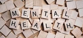 Wooden blocks spell out mental health.