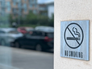 A silver sign reads, 'No Smoking.'